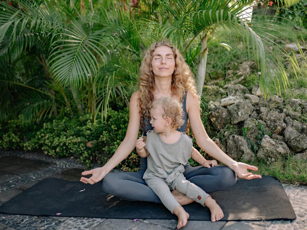women doing yoga pose with baby